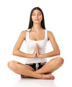 Young woman sitting in lotus position - learn kung fu online