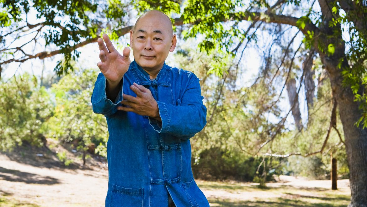 Man doing martial arts in park