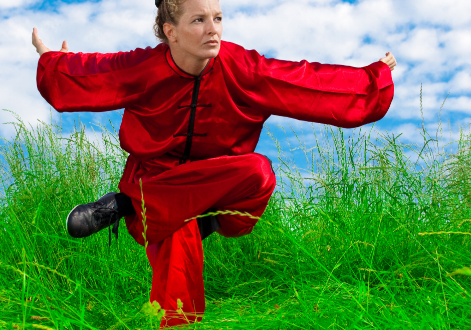 Woman practicing kung fu balance stance outside