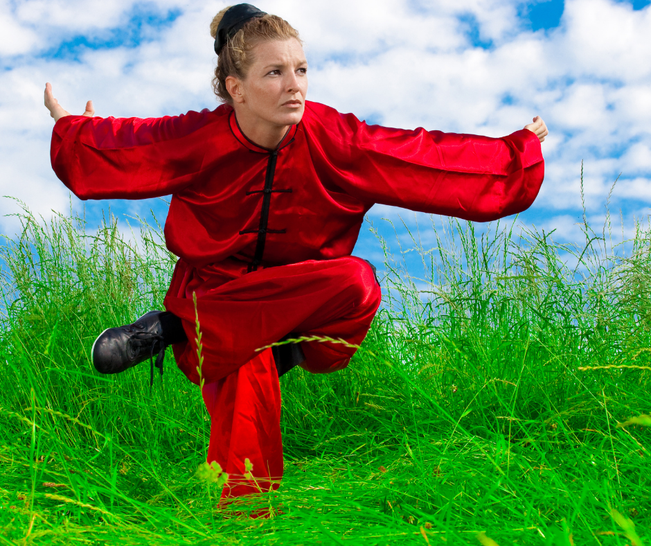 Woman practicing kung fu balance stance outside